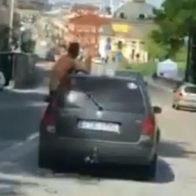 В Киева мужчина со спиртным в руках вылез из окна иномарки на полном ходу (видео)